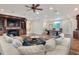 An open-concept living room with fireplace and view of a pool table at 501 Adams Barn Rd, Auburndale, FL 33823