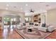 Open-concept living room with hardwood floors and arched doorway to the formal dining room at 501 Adams Barn Rd, Auburndale, FL 33823