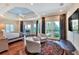 Spacious main bedroom boasts hardwood floors, a sitting area, and access to a private balcony with beautiful outdoor views at 501 Adams Barn Rd, Auburndale, FL 33823