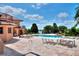 Expansive outdoor dining and lounge area by the pool with stunning lake views, perfect for entertaining at 501 Adams Barn Rd, Auburndale, FL 33823