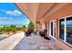 Spacious covered patio with comfortable seating offering serene water views at 501 Adams Barn Rd, Auburndale, FL 33823