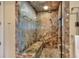 Luxurious marble walk-in shower with built-in bench and dual showerheads offers a spa-like experience in the comfort of home at 501 Adams Barn Rd, Auburndale, FL 33823