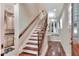 Elegant staircase featuring hardwood steps, decorative iron railings, and a bright, inviting atmosphere at 501 Adams Barn Rd, Auburndale, FL 33823