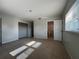 Bright bedroom features neutral walls, tile floors, closet space, and an attached bathroom at 502 Canal Dr, Lake Wales, FL 33859