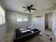 Bedroom featuring ceiling fan, large window, and access to an ensuite bathroom at 502 Canal Dr, Lake Wales, FL 33859