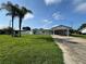 Well-maintained front yard with lush green grass leading to a cozy home featuring a convenient carport at 502 Canal Dr, Lake Wales, FL 33859