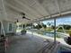 Spacious covered patio overlooking a large backyard, in-ground pool, and water slide at 502 Canal Dr, Lake Wales, FL 33859