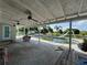 Covered patio features dual ceiling fans and an expansive view of the in-ground pool and backyard at 502 Canal Dr, Lake Wales, FL 33859