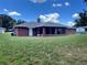 The backyard has a screened patio on this single story brick home at 504 W 7Th St, Frostproof, FL 33843