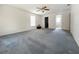 Large carpeted main bedroom with a ceiling fan and lots of sunlight at 504 W 7Th St, Frostproof, FL 33843