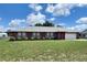 Beautiful single-story brick house with blue shutters and a well-maintained lawn on a sunny day at 504 W 7Th St, Frostproof, FL 33843
