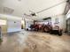 Spacious garage featuring tractor, riding mower, and ample storage space at 504 W 7Th St, Frostproof, FL 33843