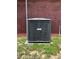 View of the air conditioning unit and brick exterior of this single story home at 504 W 7Th St, Frostproof, FL 33843