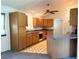 View of the kitchen featuring wood cabinets, a ceiling fan, and ample counter space at 504 W 7Th St, Frostproof, FL 33843