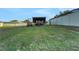 Spacious backyard featuring boat storage and a well-maintained lawn, perfect for outdoor activities at 505 8Th S St, Dundee, FL 33838