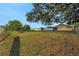 Expansive backyard with mature trees, a playset, and a view of the home's rear exterior at 505 8Th S St, Dundee, FL 33838