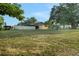 Large backyard with a privacy fence, playset and covered lanai, ideal for Gathering fun and entertaining at 505 8Th S St, Dundee, FL 33838