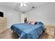 Bright bedroom featuring a cozy bed with a blue comforter and hardwood floors at 505 8Th S St, Dundee, FL 33838