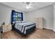 Bedroom with hardwood floors, a window and blue curtains at 505 8Th S St, Dundee, FL 33838