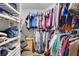 Walk-in closet providing ample storage with custom shelving and hanging racks at 505 8Th S St, Dundee, FL 33838