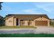 Well-maintained single-Gathering home showcasing a tidy front yard and an attached two-car garage at 505 8Th S St, Dundee, FL 33838