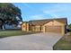 Charming single-story home featuring a well-maintained lawn and an expansive concrete driveway at 505 8Th S St, Dundee, FL 33838