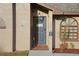 Close-up of front entrance featuring a decorative door with a welcome sign and tasteful landscaping at 505 8Th S St, Dundee, FL 33838