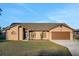 Beautiful exterior view of the single-story home and attached garage at 505 8Th S St, Dundee, FL 33838