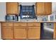 Kitchen features oak cabinets, stainless steel appliances, and tiled backsplash at 505 8Th S St, Dundee, FL 33838