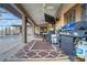 Covered patio with a grill, television, and ample seating for outdoor entertaining and relaxation at 505 8Th S St, Dundee, FL 33838