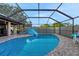 Inviting screened-in pool area with a slide and ample space for relaxation and recreation at 505 8Th S St, Dundee, FL 33838