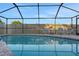 Inviting screened in pool area with clear blue water and lounge seating at 505 8Th S St, Dundee, FL 33838
