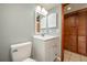 Bathroom with a single vanity and a toilet, illuminated by modern lighting at 5102 Village Ct # E-2, Lake Wales, FL 33898