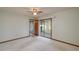 Bright bedroom featuring a sliding door with access to a screened-in patio at 5102 Village Ct # E-2, Lake Wales, FL 33898