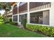 Condo rear exterior view showcasing a screened-in lanai and well-manicured lawn at 5102 Village Ct # E-2, Lake Wales, FL 33898