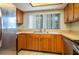 The kitchen includes stainless steel appliances, ample wood cabinets, and a sink overlooking the outdoors at 5102 Village Ct # E-2, Lake Wales, FL 33898