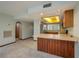 A bright kitchen featuring wood cabinets, laminate countertops, and stainless steel appliances at 5102 Village Ct # E-2, Lake Wales, FL 33898