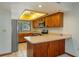The kitchen boasts wood cabinetry, light countertops, and a stainless steel microwave at 5102 Village Ct # E-2, Lake Wales, FL 33898