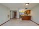 Inviting living room with open layout adjacent to kitchen, light carpet, and tile flooring at 5102 Village Ct # E-2, Lake Wales, FL 33898