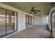 Relaxing covered patio featuring a ceiling fan and access to the indoors through sliding glass doors at 5102 Village Ct # E-2, Lake Wales, FL 33898