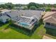 Aerial view of a home's backyard with a pool and green grass at 560 Saint Andrews Rd, Winter Haven, FL 33884