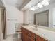 A cozy bathroom has an oak vanity and neutral tile at 560 Saint Andrews Rd, Winter Haven, FL 33884