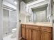 Bathroom featuring wood vanity, sink, toilet, and shower at 560 Saint Andrews Rd, Winter Haven, FL 33884