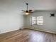 A bedroom has modern wood-look tile flooring and plenty of natural light at 560 Saint Andrews Rd, Winter Haven, FL 33884