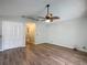 Bright bedroom featuring wood-look floors, ceiling fan, and closet at 560 Saint Andrews Rd, Winter Haven, FL 33884