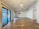 Bright living room featuring stylish tile floors, a modern ceiling fan, and sliding doors to a screened patio at 560 Saint Andrews Rd, Winter Haven, FL 33884