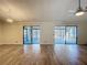 Spacious living room featuring stylish tile floors, a modern ceiling fan, and sliding doors to a screened patio at 560 Saint Andrews Rd, Winter Haven, FL 33884