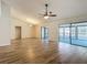 Spacious living room featuring stylish tile floors, a modern ceiling fan, and sliding doors to a screened patio at 560 Saint Andrews Rd, Winter Haven, FL 33884