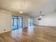Bright living room featuring stylish tile floors, a modern ceiling fan, and sliding doors to a screened patio at 560 Saint Andrews Rd, Winter Haven, FL 33884