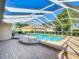The pool area features brick pavers and a screened enclosure at 560 Saint Andrews Rd, Winter Haven, FL 33884